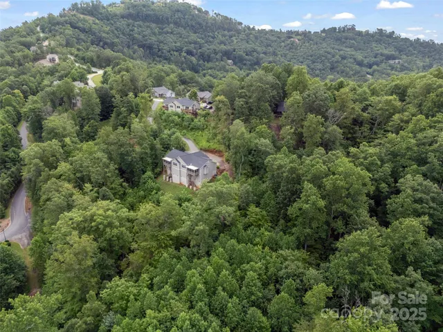 an aerial view of a house with mountain view