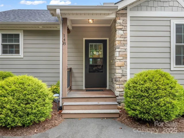 a front view of a house with a garden