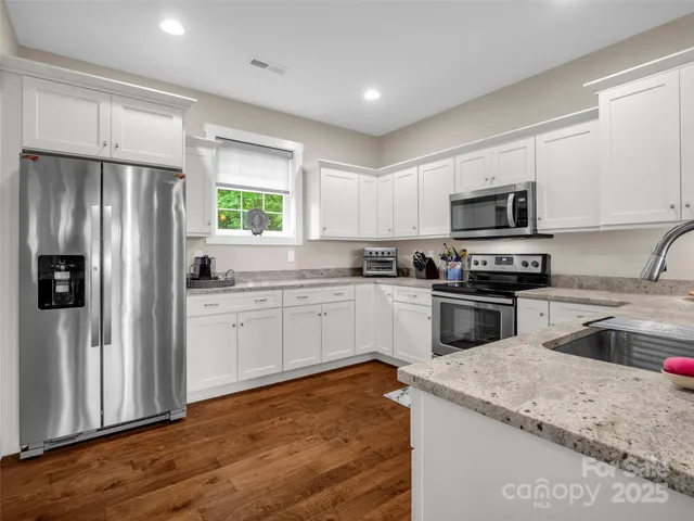 a kitchen with a refrigerator stove and microwave