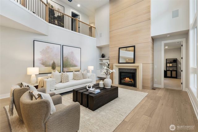 a living room with furniture large window and a fireplace