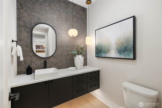 a bathroom with a toilet sink and mirror