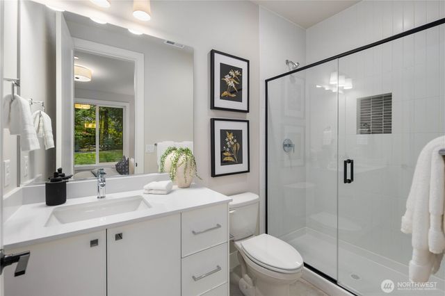 a bathroom with a double vanity sink toilet and shower