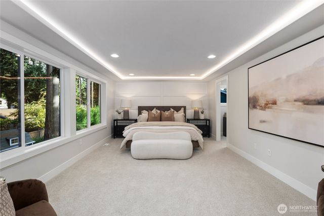 a spacious bedroom with a large bed and a large window