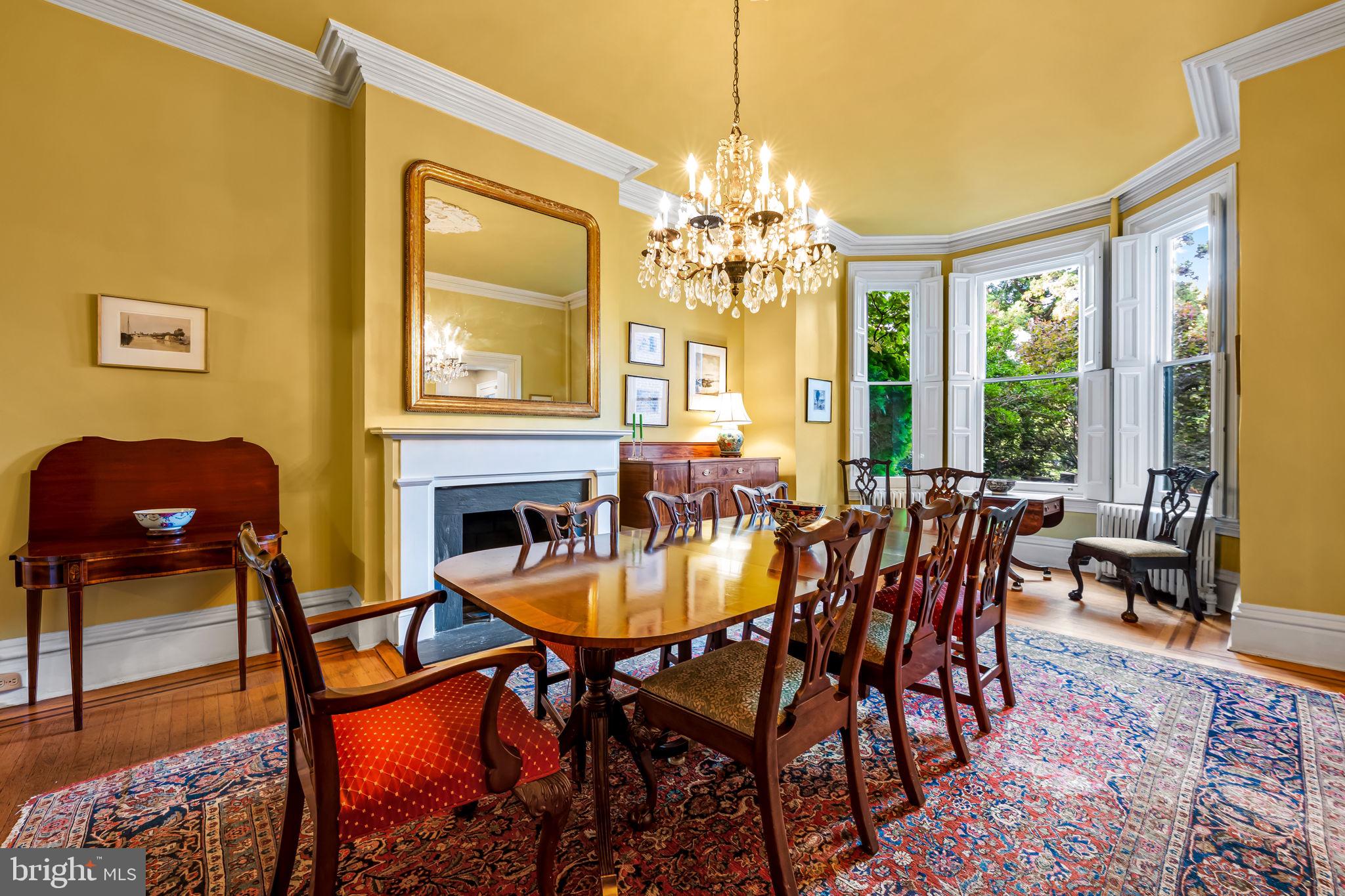 1310 Bolton Street Baltimore, MD 21217 - Photo 19 of 69 a view of a dining room with furniture a chandelier and wooden floor