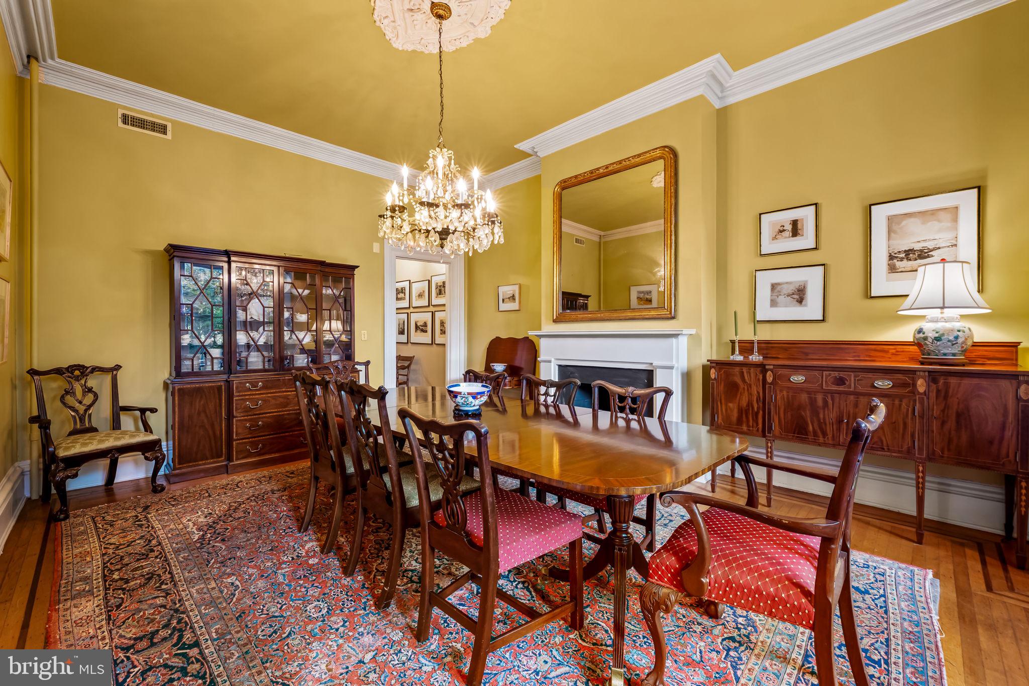 1310 Bolton Street Baltimore, MD 21217 - Photo 22 of 69 a view of a dining room with furniture a chandelier and wooden floor