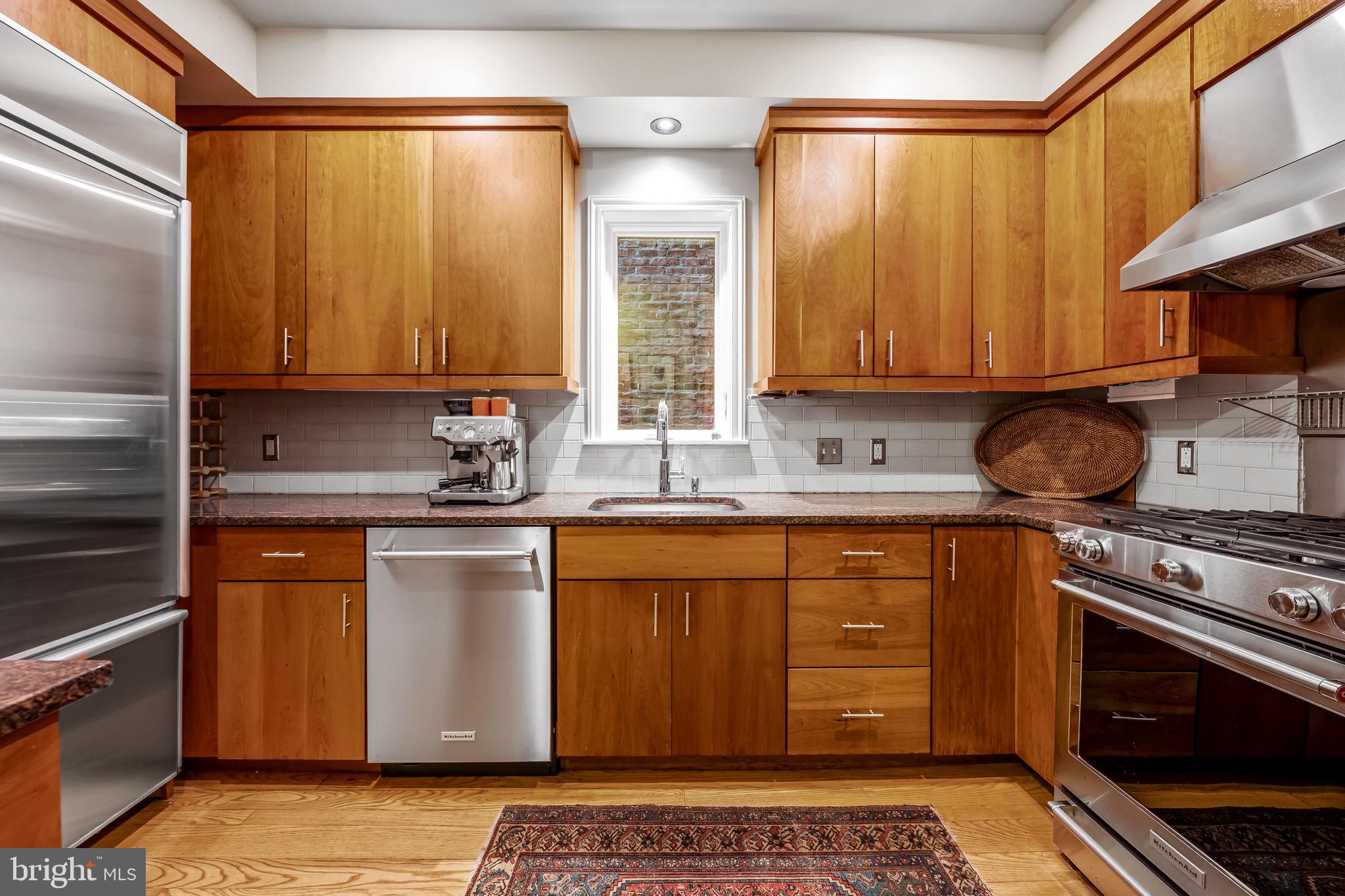 1310 Bolton Street Baltimore, MD 21217 - Photo 23 of 69 a kitchen with stainless steel appliances granite countertop a stove a sink and a microwave