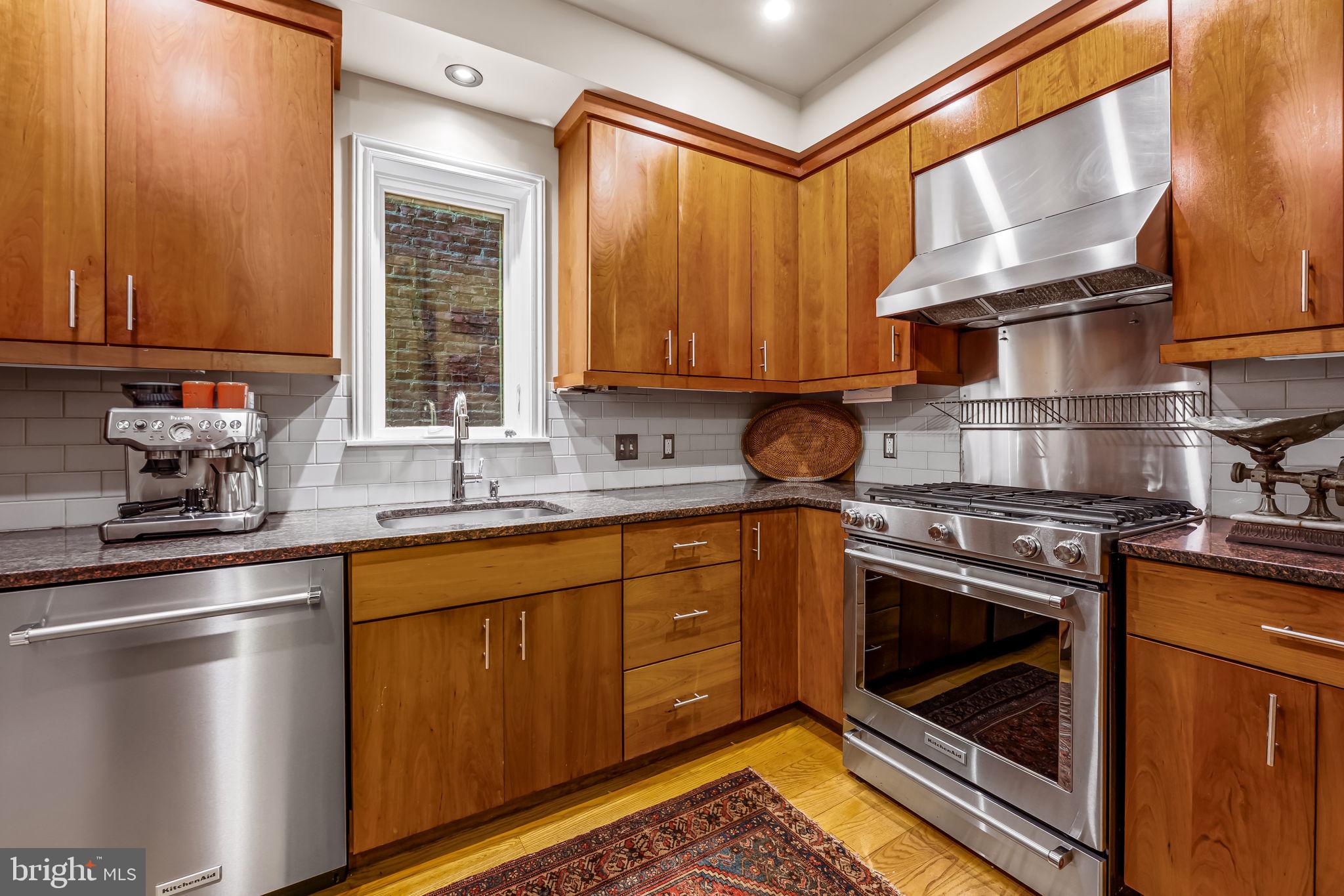 1310 Bolton Street Baltimore, MD 21217 - Photo 24 of 69 a kitchen with stainless steel appliances granite countertop a sink stove and refrigerator