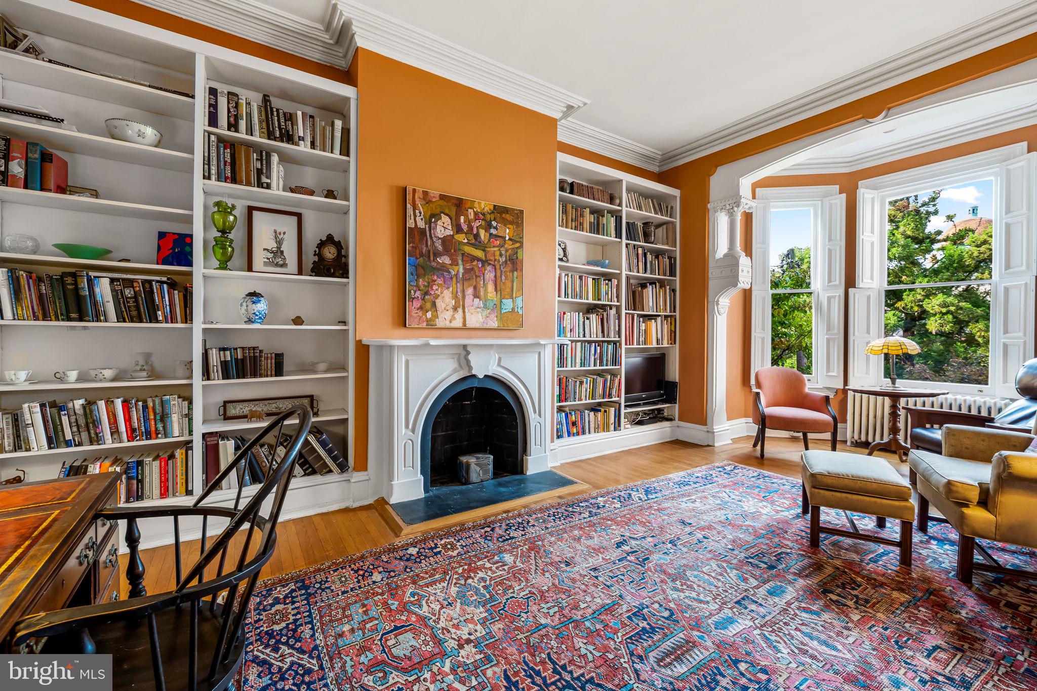 1310 Bolton Street Baltimore, MD 21217 - Photo 35 of 69 a living room with furniture a fireplace and a book shelf