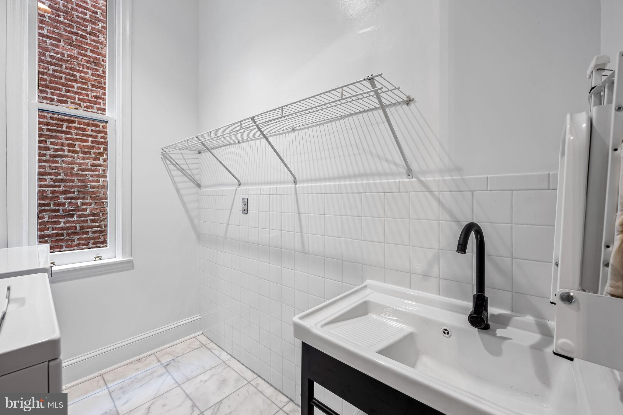 1310 Bolton Street Baltimore, MD 21217 - Photo 39 of 69 a bathroom with a sink and a mirror