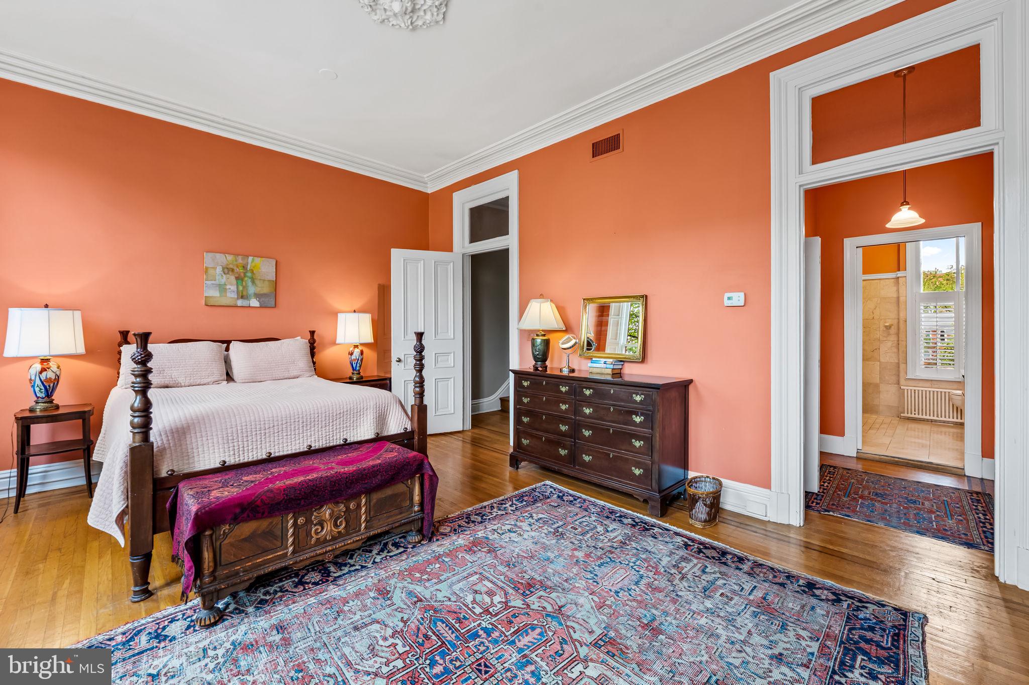 1310 Bolton Street Baltimore, MD 21217 - Photo 40 of 69 a bedroom with a bed and wooden floor