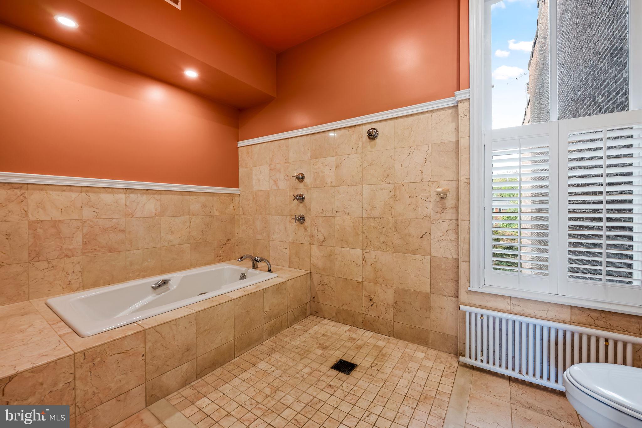 1310 Bolton Street Baltimore, MD 21217 - Photo 43 of 69 a bathroom with a bathtub and a shower