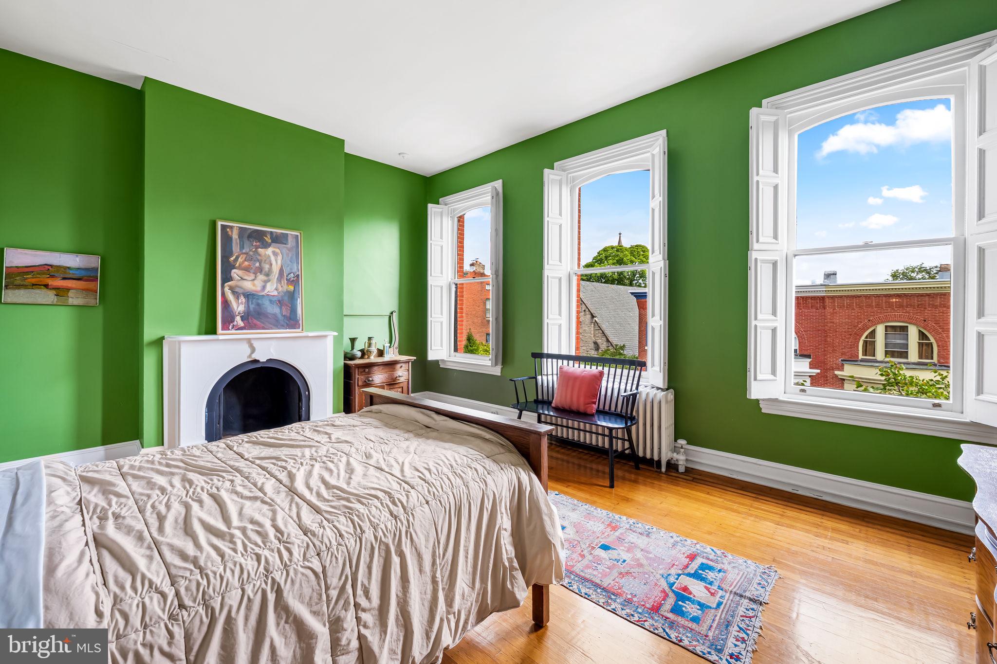 1310 Bolton Street Baltimore, MD 21217 - Photo 47 of 69 a bedroom with a bed and a fireplace