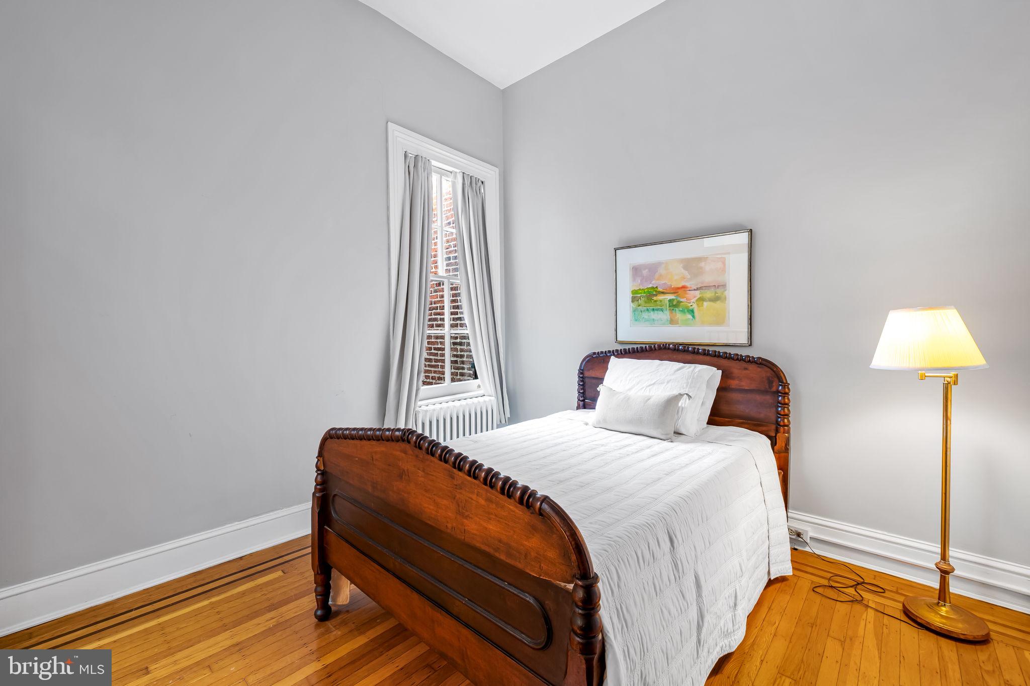 1310 Bolton Street Baltimore, MD 21217 - Photo 49 of 69 a bedroom with a bed and a lamp