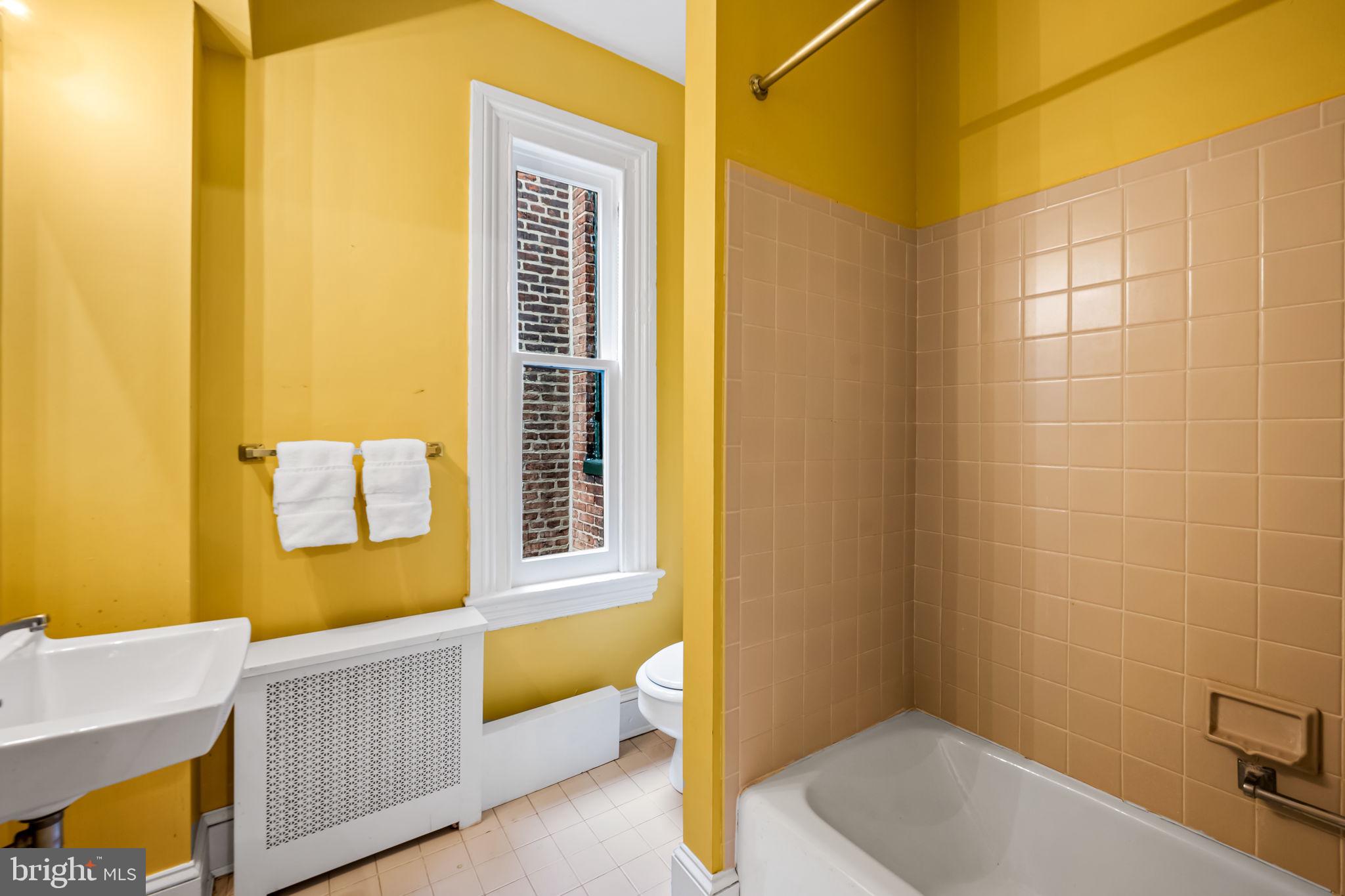 1310 Bolton Street Baltimore, MD 21217 - Photo 53 of 69 a bathroom with a tub a sink and a window