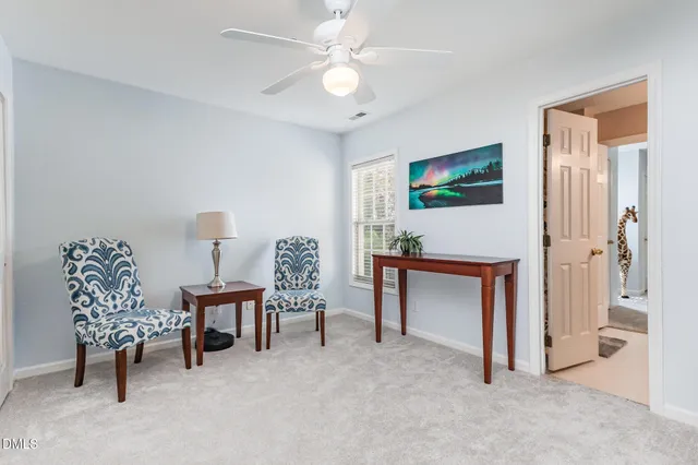 a living room with furniture a desk and a painting