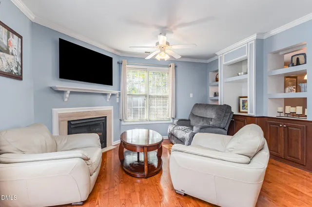 a living room with furniture fireplace and flat screen tv
