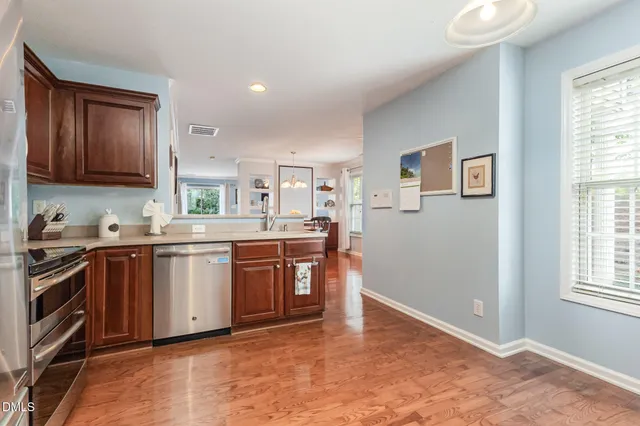 a kitchen with stainless steel appliances granite countertop a stove and a sink