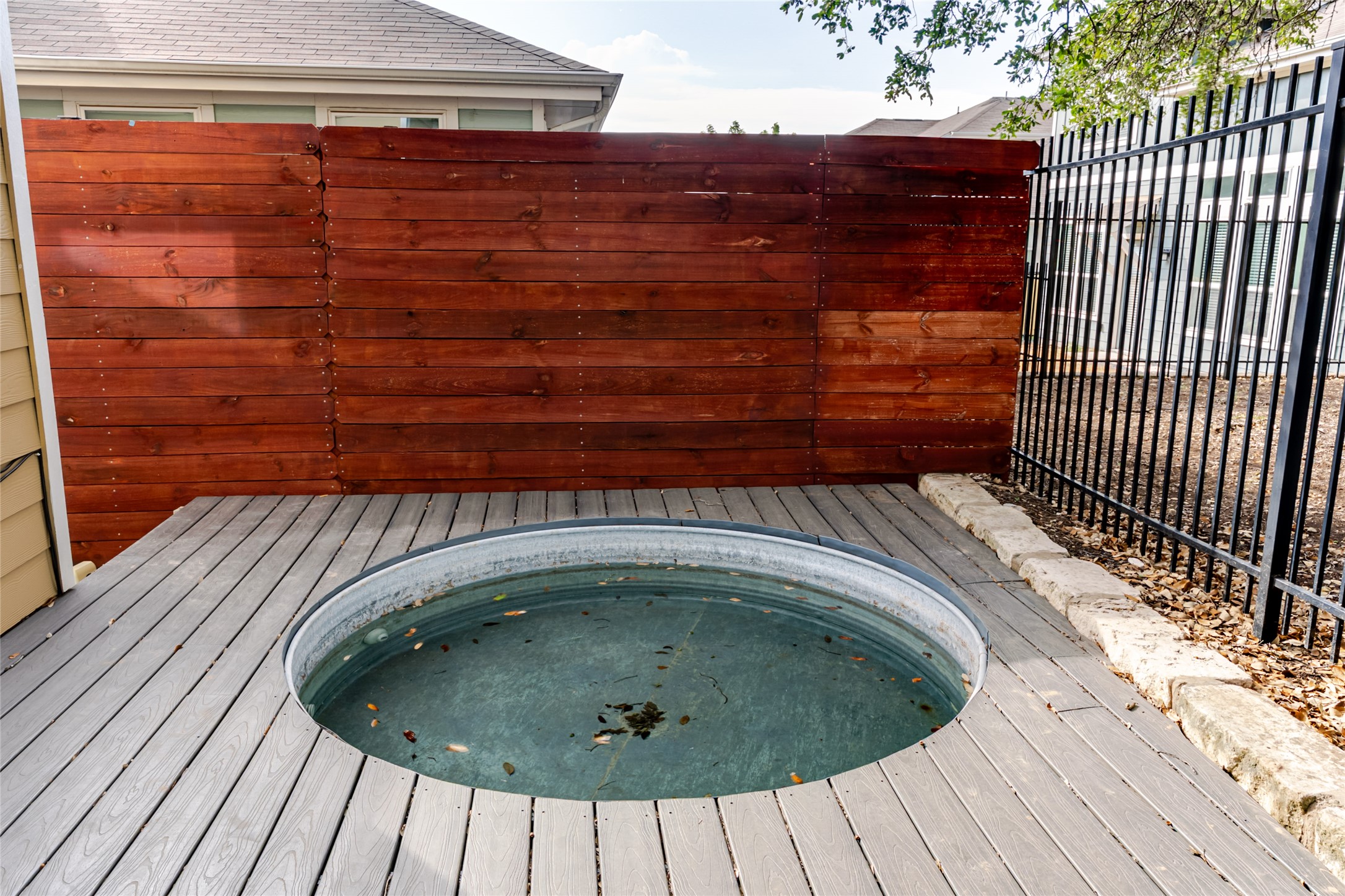 1400 Homespun Road Austin, TX 78745 - Photo 29 of 30 An inviting stock tank pool is seamlessly integrated into a handsome wooden deck.