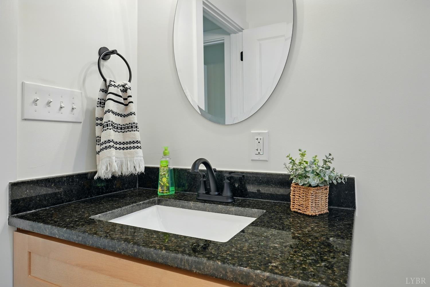 3470 Double Bridges Road Spout Spring, VA 24593 - Photo 28 of 40 a bathroom with a granite countertop sink a mirror and vanity