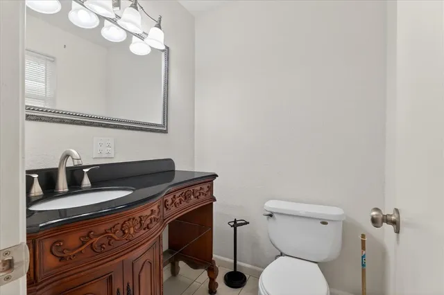 a bathroom with a toilet a sink and mirror