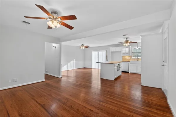 a view of an empty room and wooden floor