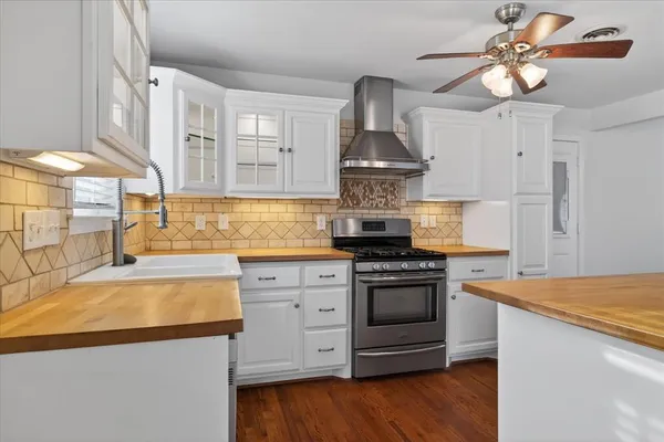 a kitchen with stainless steel appliances a stove a sink and a refrigerator