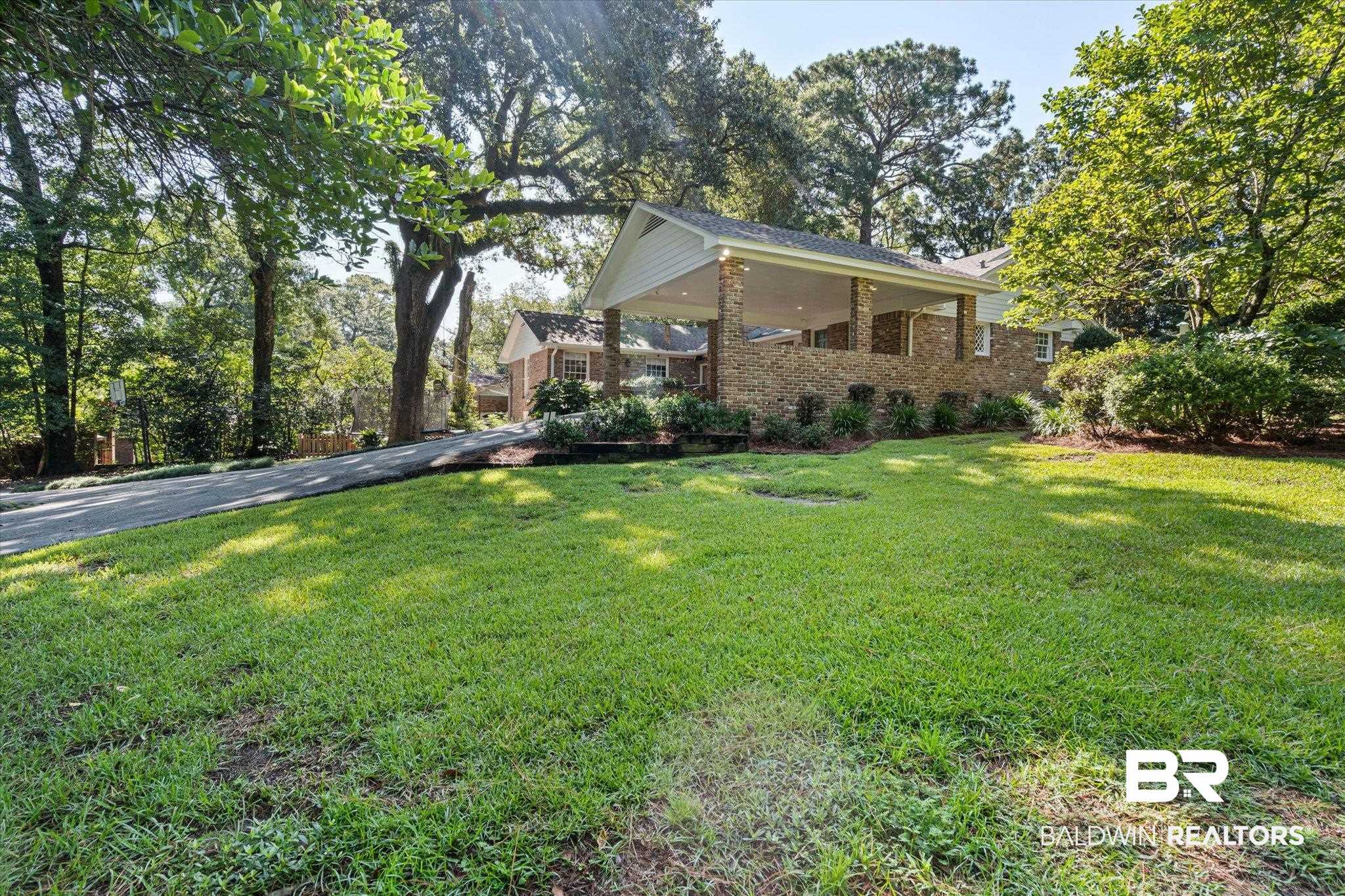 3612 Linden Lane Mobile, AL 36608 - Photo 41 of 42 View of side of property with a lawn and brick siding
