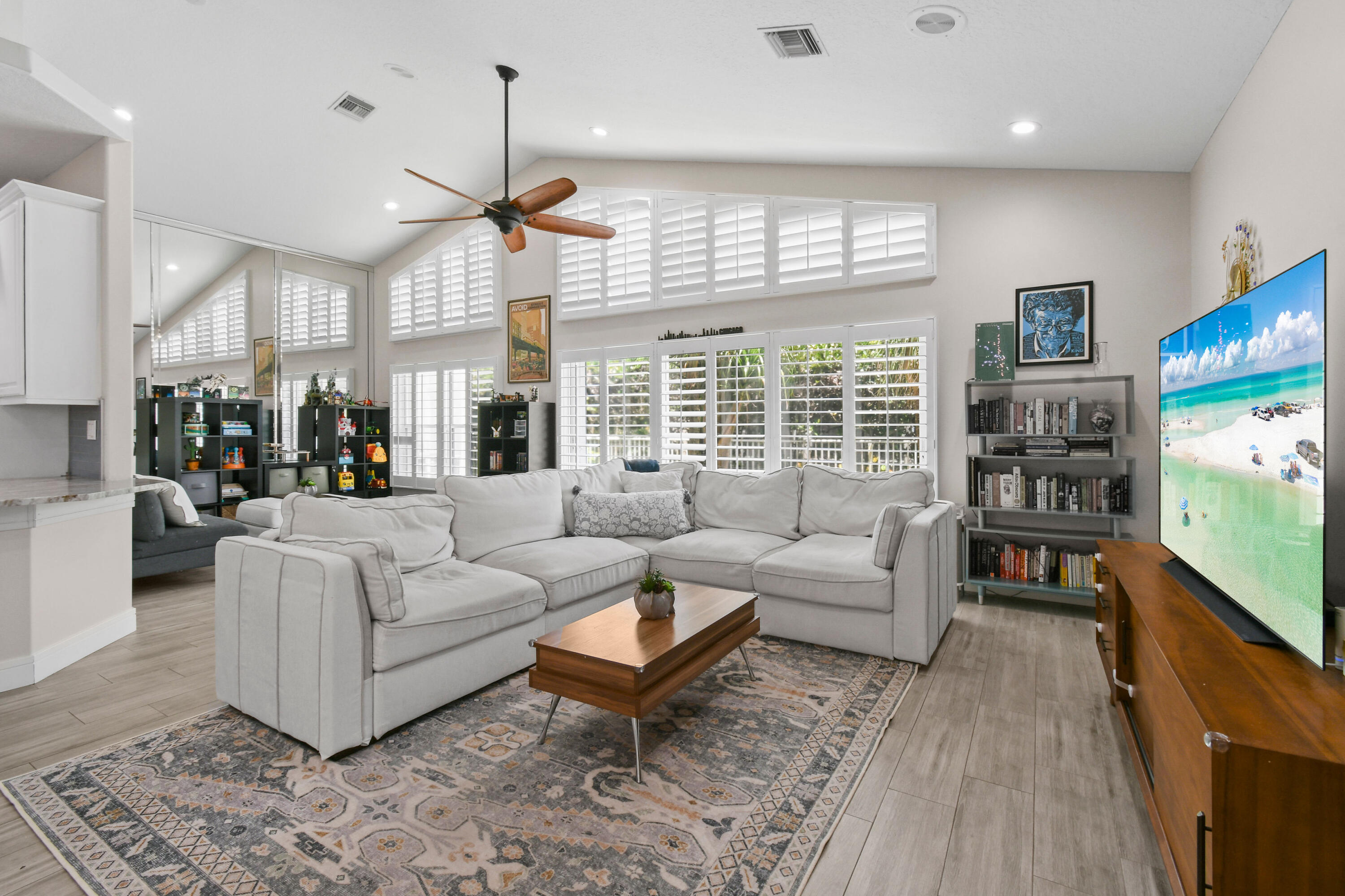 303 Hardwood Point Jupiter, FL 33458 - Photo 11 of 75 a living room with furniture a flat screen tv and a large window