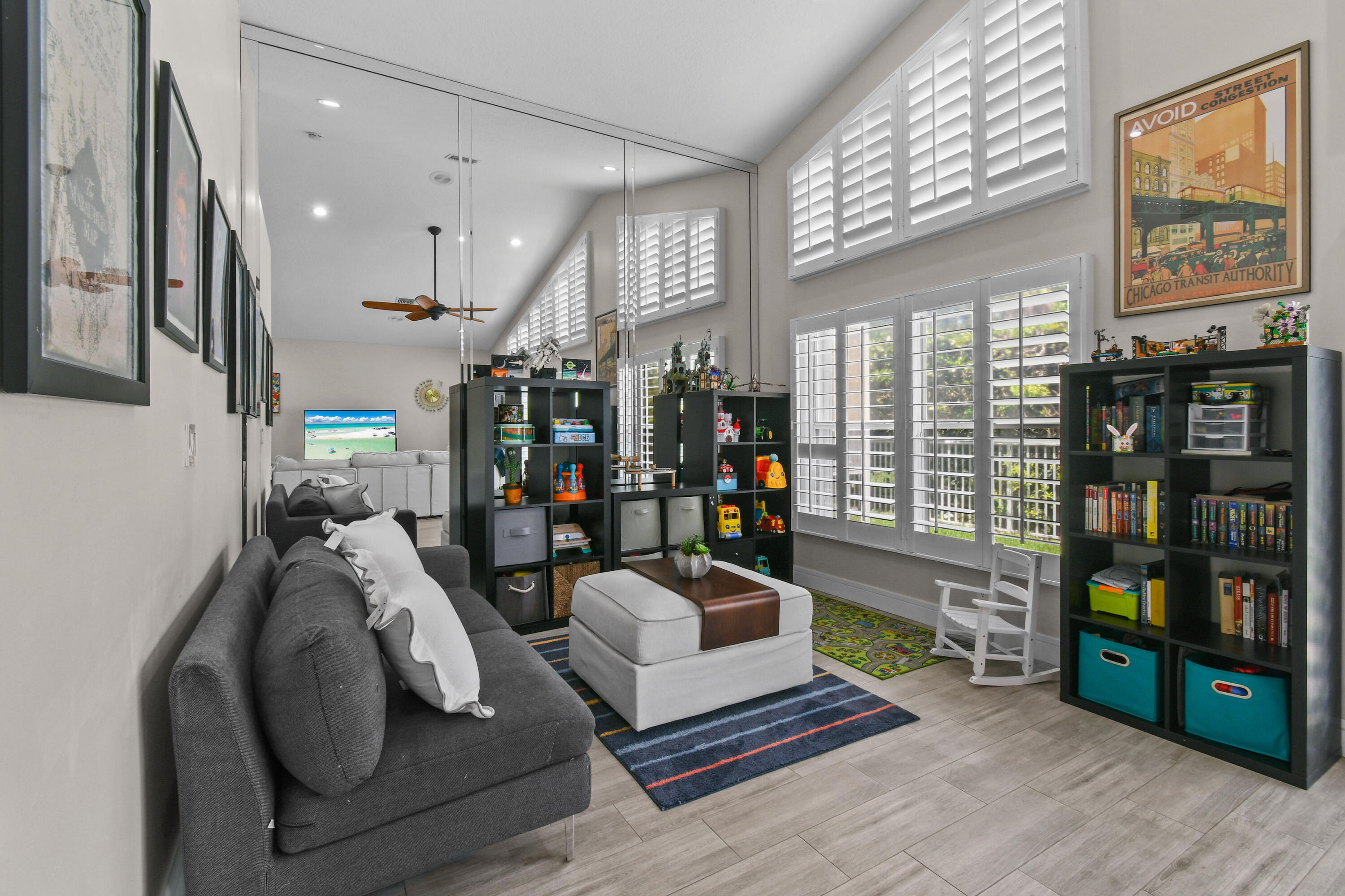 303 Hardwood Point Jupiter, FL 33458 - Photo 17 of 75 a living room with lots of furniture and book shelf