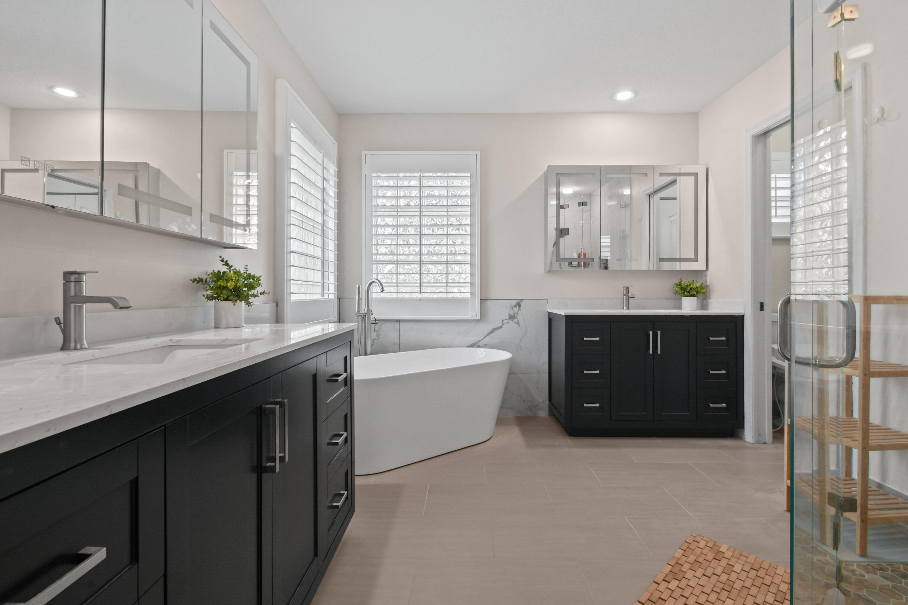 303 Hardwood Point Jupiter, FL 33458 - Photo 30 of 75 a spacious bathroom with a granite countertop double vanity sink a bathtub and window