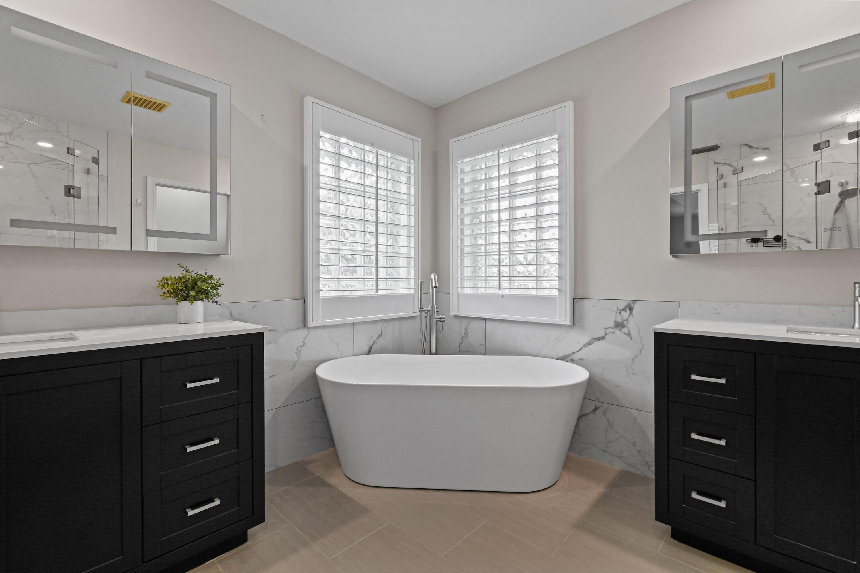 303 Hardwood Point Jupiter, FL 33458 - Photo 33 of 75 a spacious bathroom with a tub sink and mirror