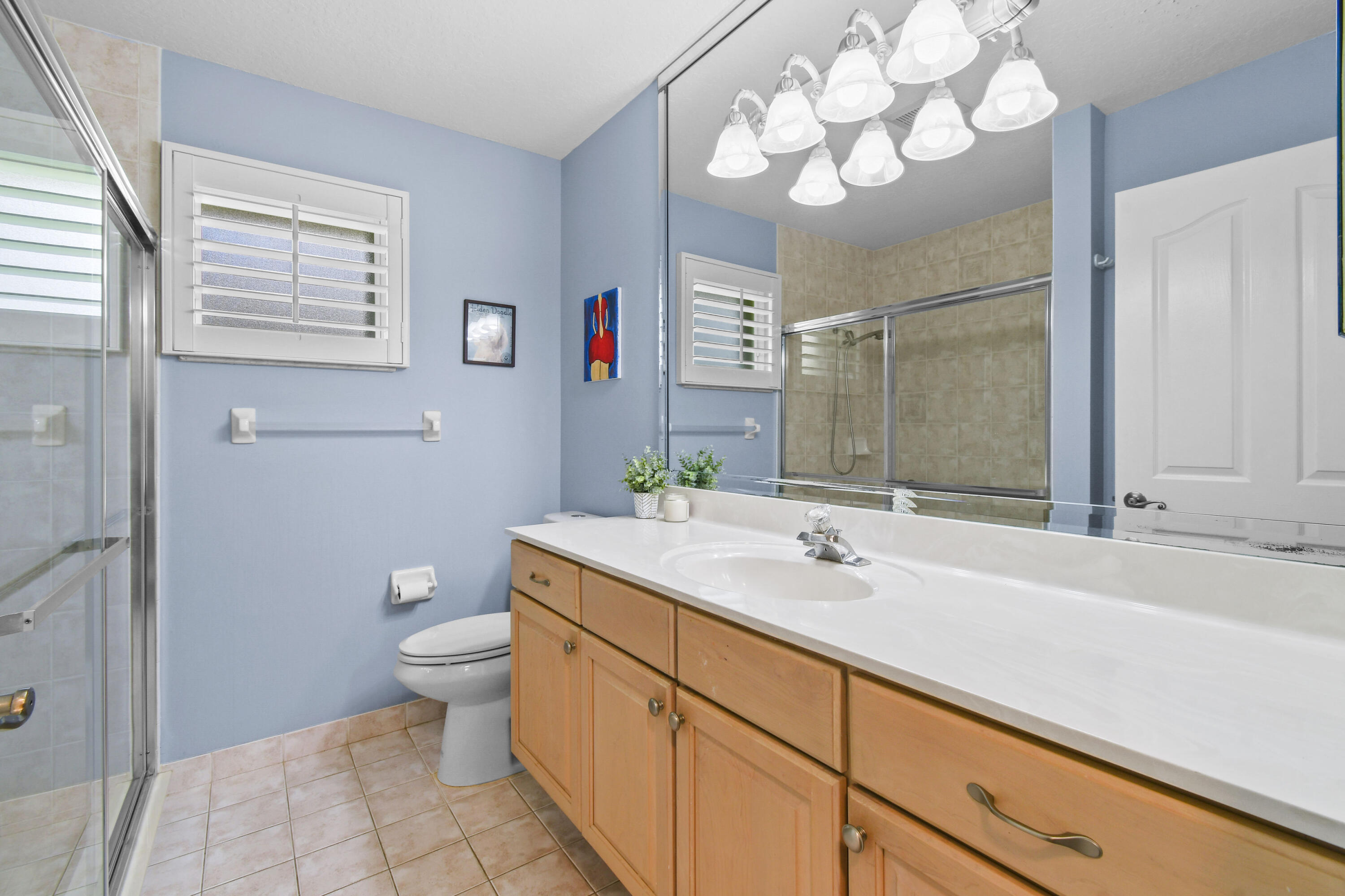 303 Hardwood Point Jupiter, FL 33458 - Photo 38 of 75 a bathroom with a sink a toilet and a mirror