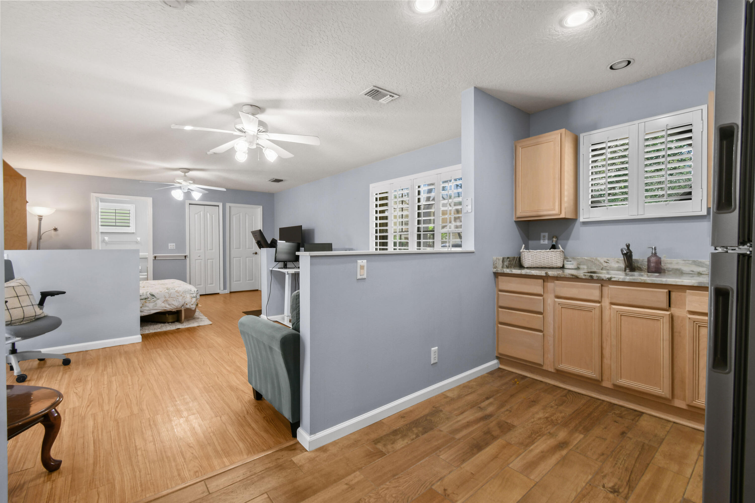 303 Hardwood Point Jupiter, FL 33458 - Photo 43 of 75 a kitchen with kitchen island a counter top space a sink a window and stainless steel appliances