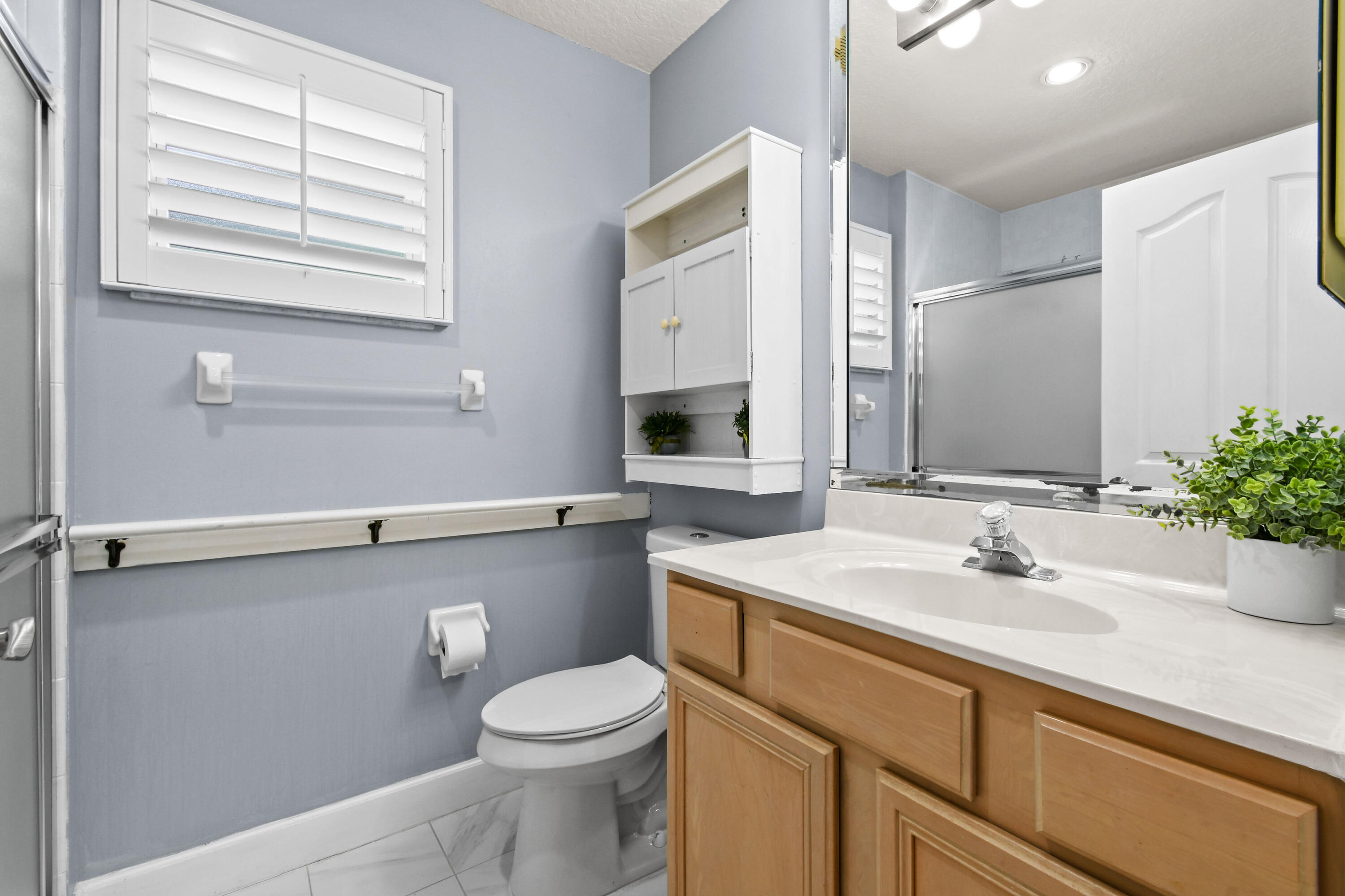 303 Hardwood Point Jupiter, FL 33458 - Photo 52 of 75 a bathroom with a sink a toilet and mirror