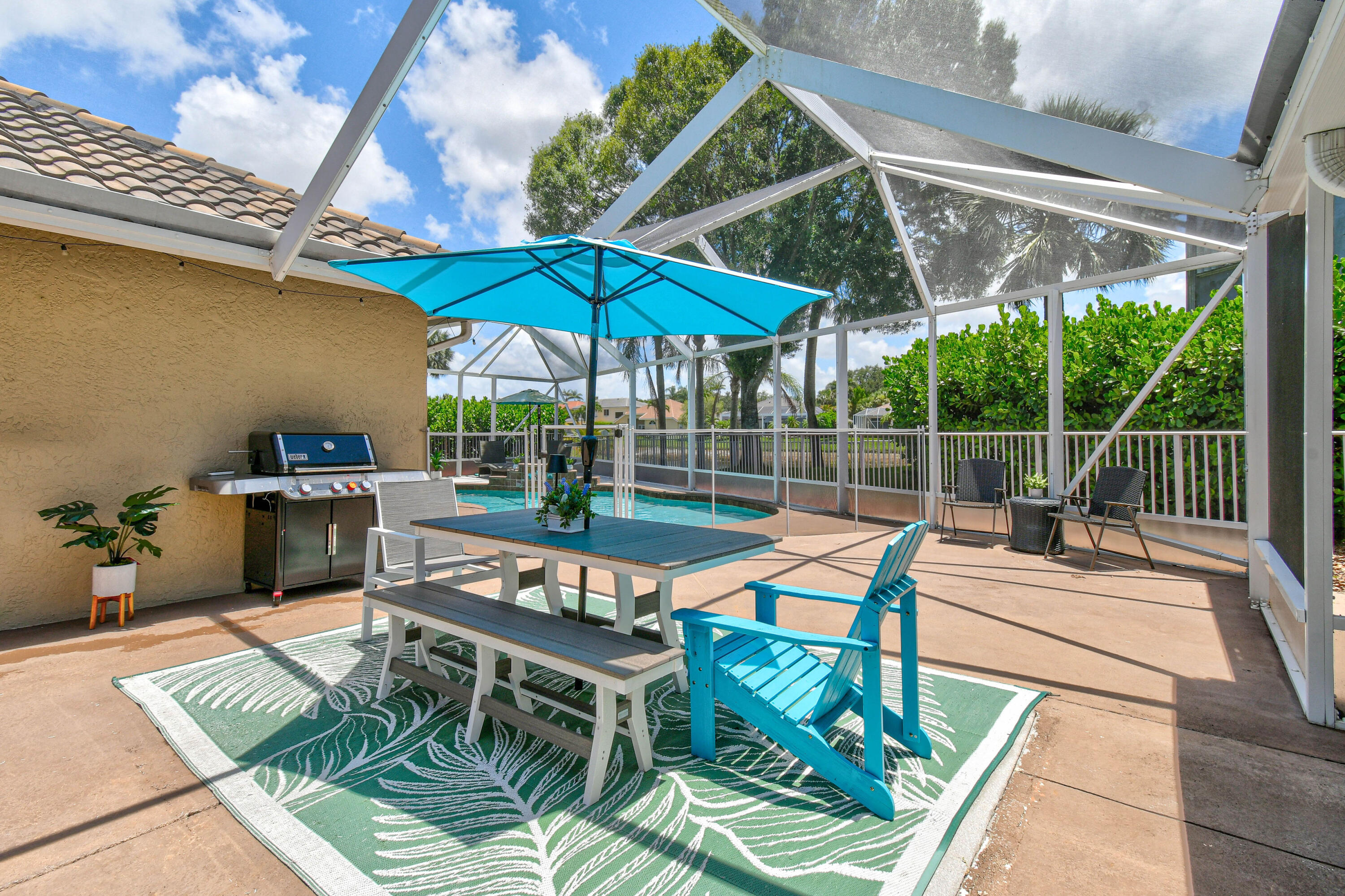 303 Hardwood Point Jupiter, FL 33458 - Photo 54 of 75 a view of an outdoor sitting area with furniture and umbrella