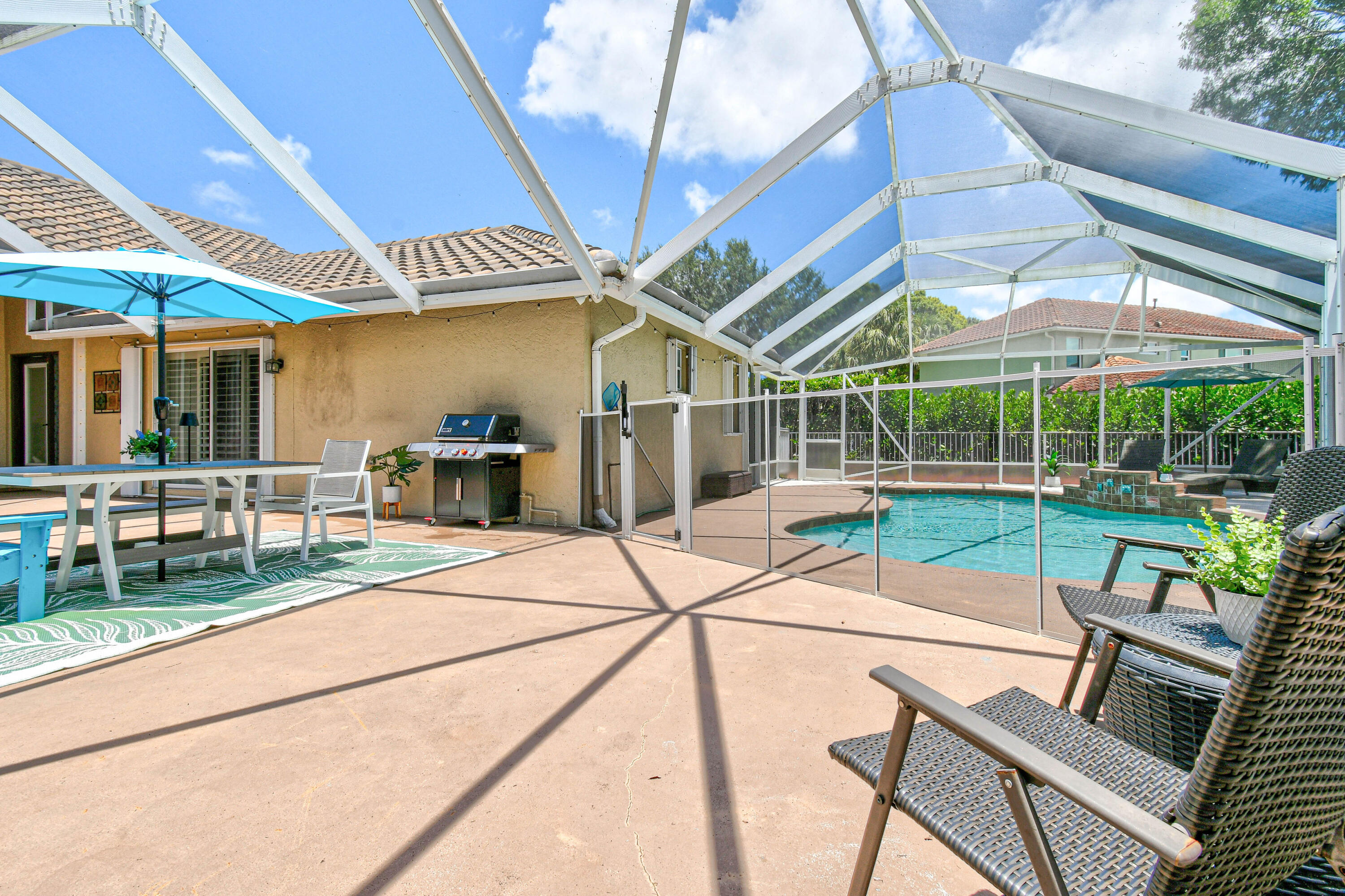303 Hardwood Point Jupiter, FL 33458 - Photo 7 of 75 a view of a patio with a table and chairs