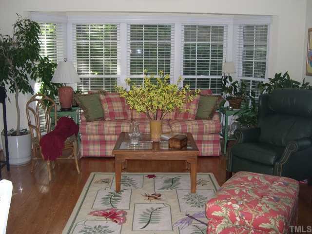 5401 Chilham Place Raleigh, NC 27612 - Photo 8 of 8 a living room with furniture and a potted plant