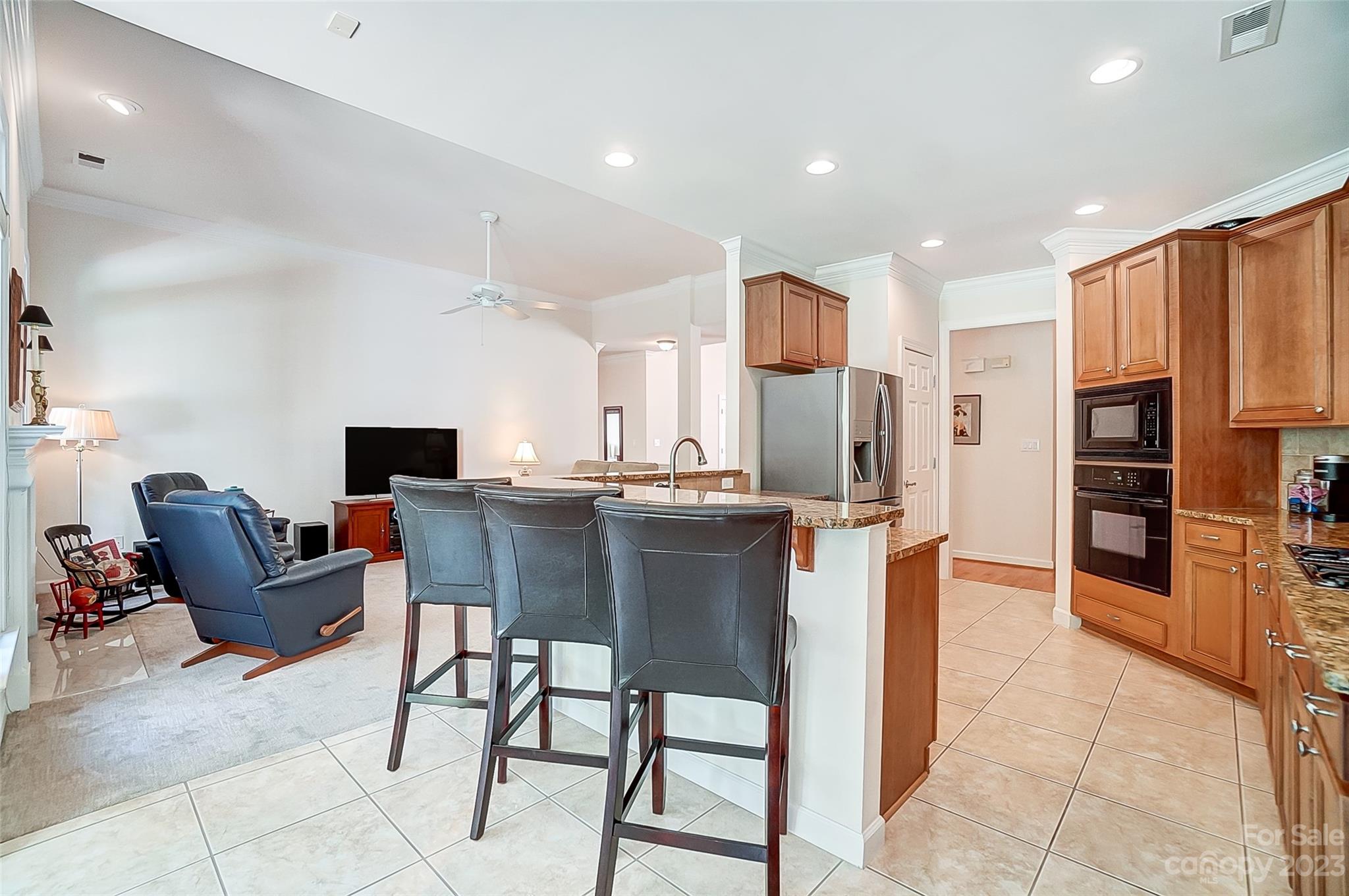 203 Shoreline Parkway Tega Cay, SC 29708 - Photo 13 of 42 a kitchen with stainless steel appliances kitchen island granite countertop a refrigerator and a stove top oven