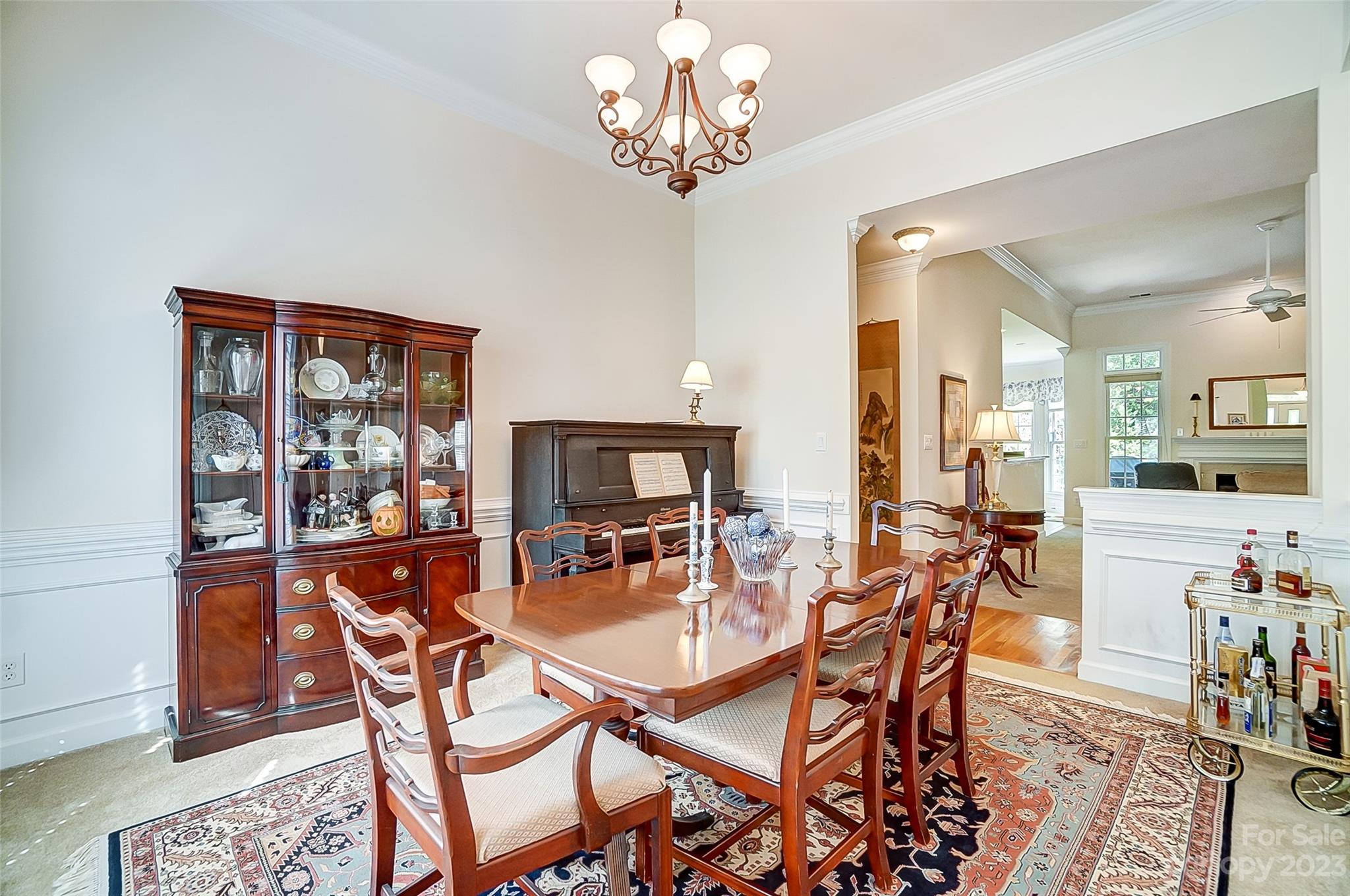 203 Shoreline Parkway Tega Cay, SC 29708 - Photo 21 of 42 a dining room with furniture a chandelier and wooden floor