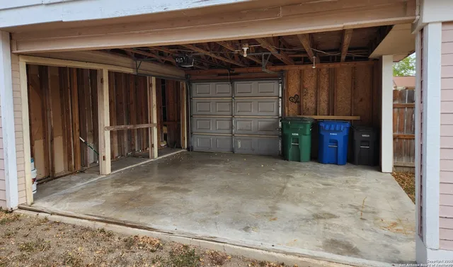 a view of an empty room with closet and a window
