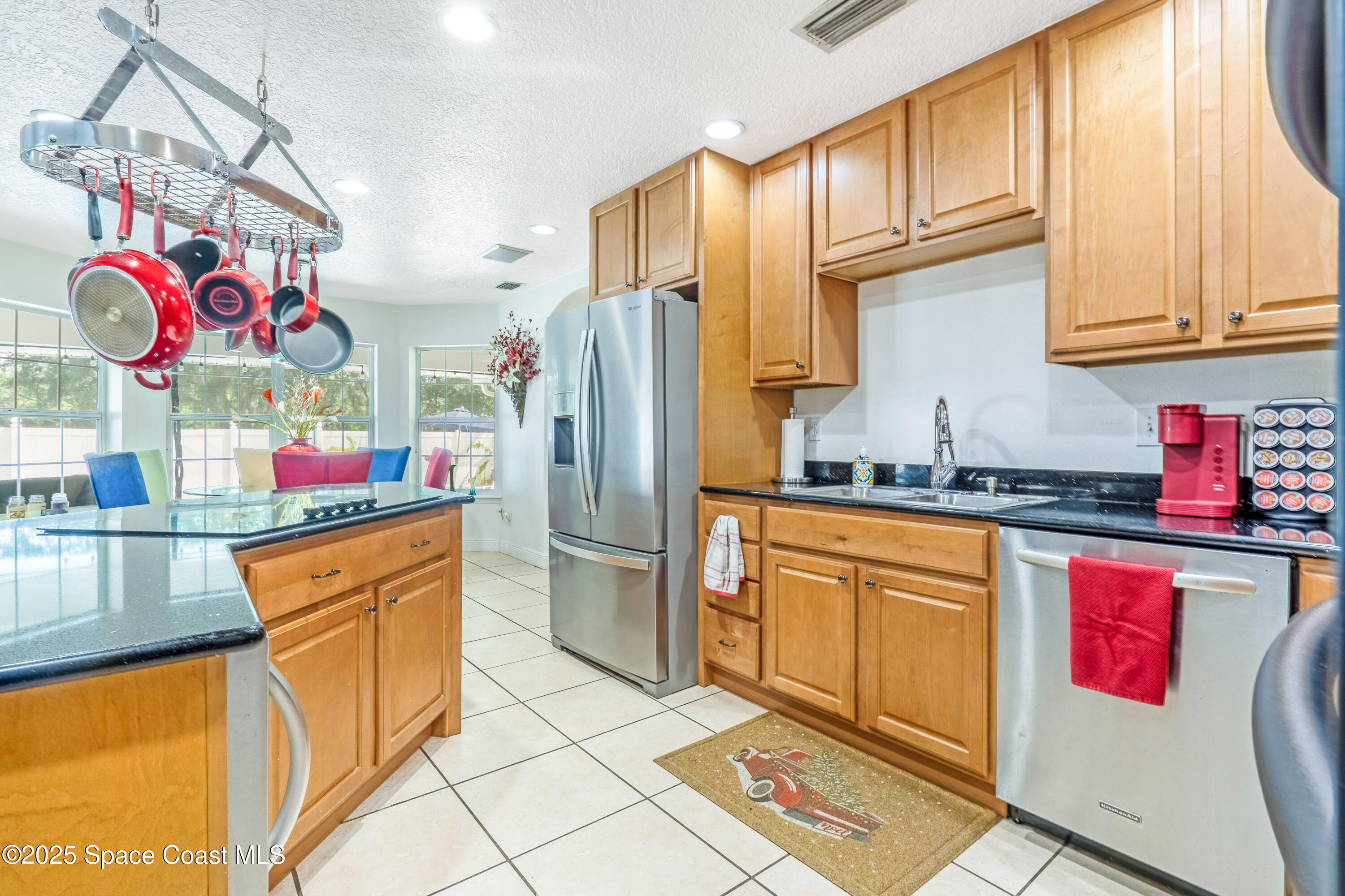 4985 Hamlin Circle Mims, FL 32754 - Photo 8 of 39 a kitchen with stainless steel appliances granite countertop a refrigerator and a stove top oven