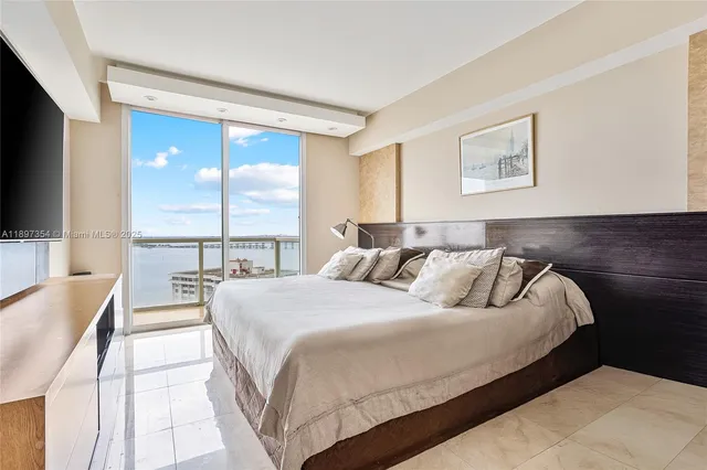 a bedroom with a large bed and a window