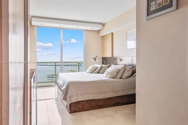 a bedroom with a bed and a painting on the wall