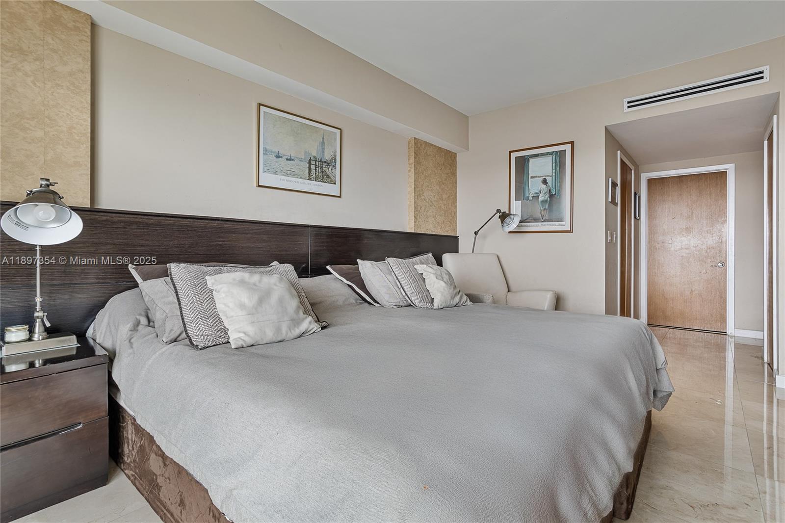 218 Southeast 14th Street, Unit 2105 Miami, FL 33131 - Photo 17 of 36 a bedroom with a bed and a painting on the wall