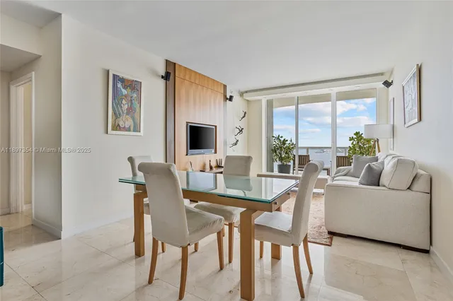 a living room with furniture a table and a large window