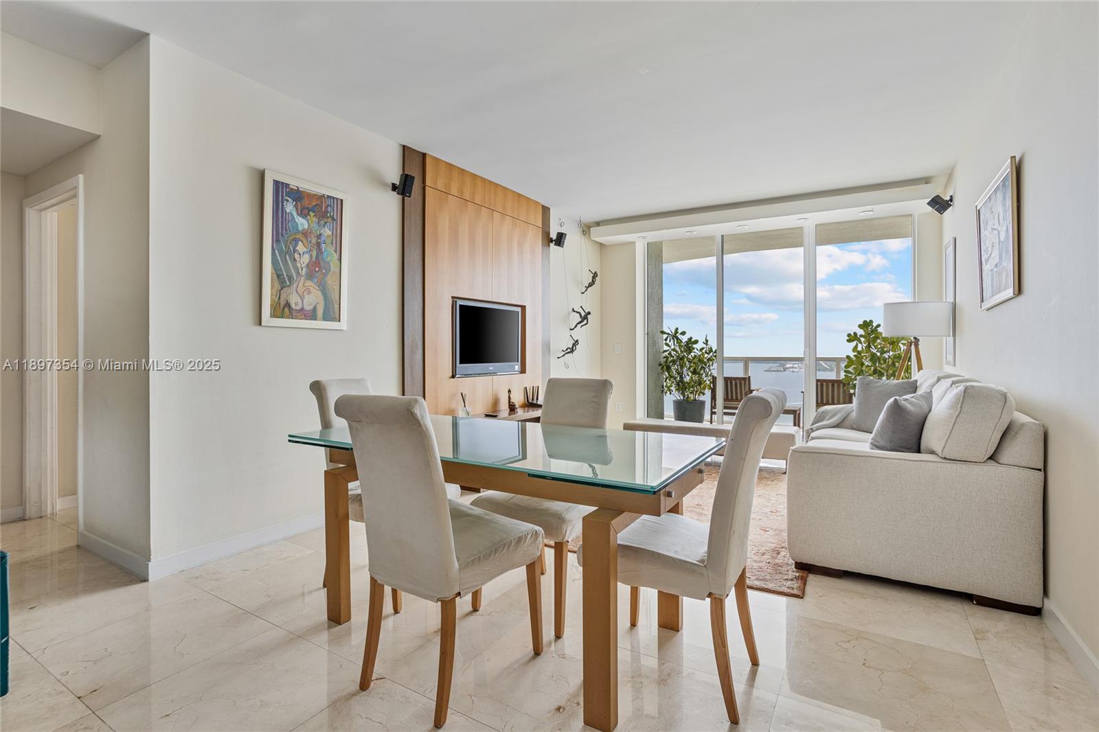 218 Southeast 14th Street, Unit 2105 Miami, FL 33131 - Photo 2 of 36 a living room with furniture a table and a large window