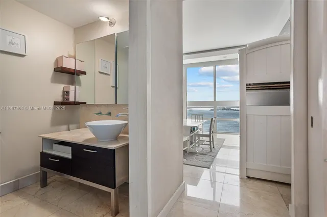 a bathroom with a sink toilet a mirror and shower