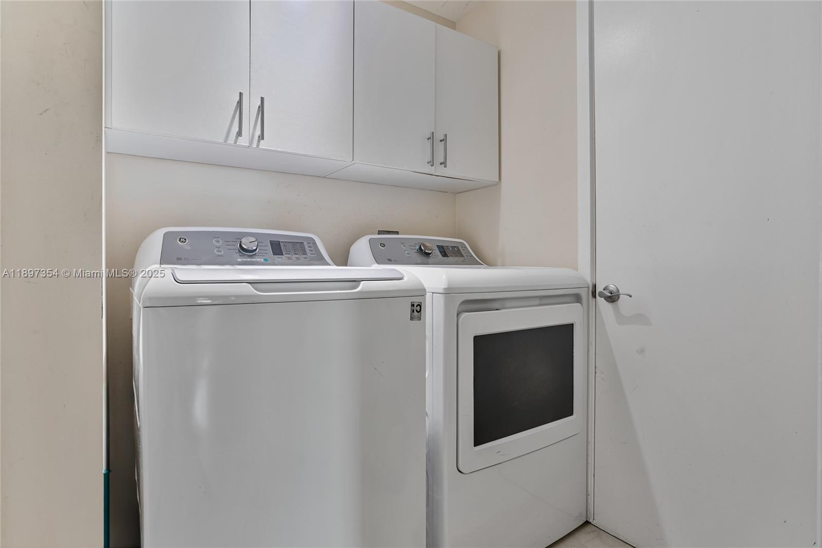 218 Southeast 14th Street, Unit 2105 Miami, FL 33131 - Photo 24 of 36 a utility room with dryer and washer