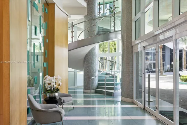 a living room with lots of furniture and a large window