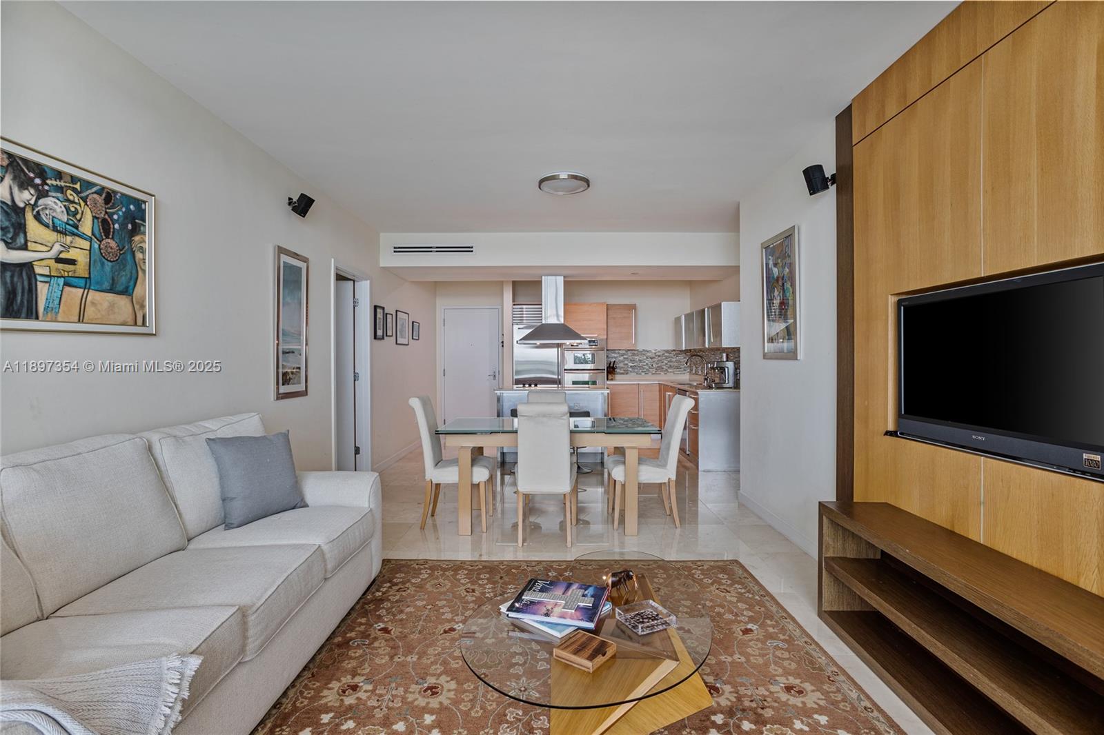 218 Southeast 14th Street, Unit 2105 Miami, FL 33131 - Photo 5 of 36 a living room with furniture and a flat screen tv